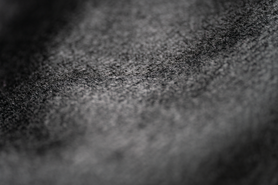 Macro shot showcasing the intricate texture of black fabric material.